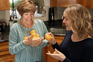 Marsha and Karen holding oranges